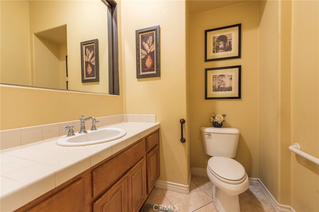 10281 Hillside Road Rancho Cucamonga, CA 91737 - Photo 20 of 60 a bathroom with a toilet sink and mirror
