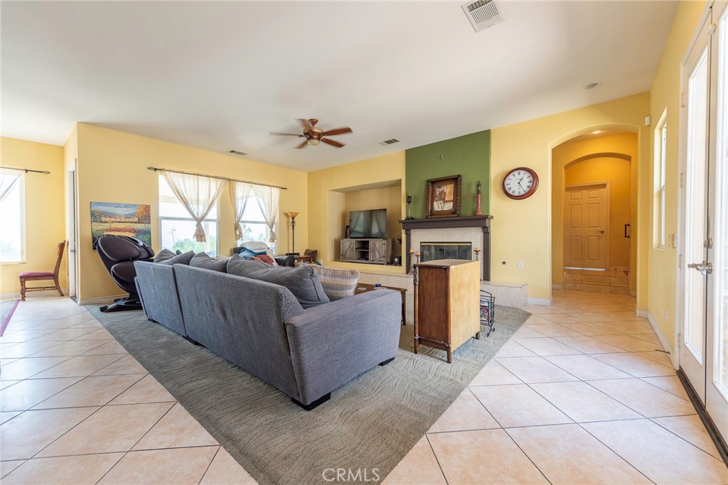 10281 Hillside Road Rancho Cucamonga, CA 91737 - Photo 21 of 60 a living room with furniture and a fireplace