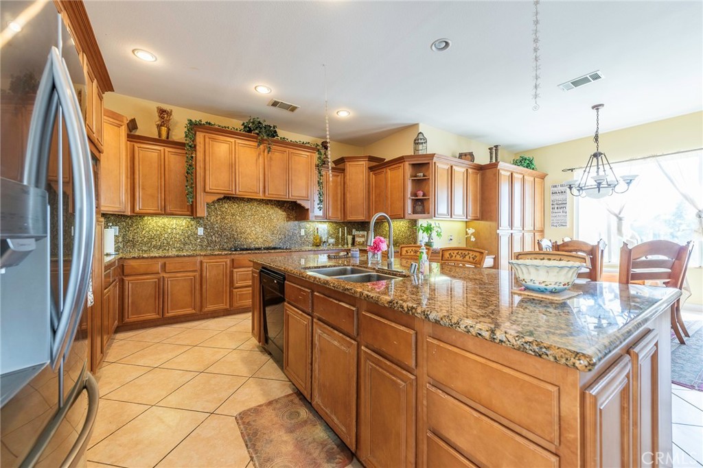 10281 Hillside Road Rancho Cucamonga, CA 91737 - Photo 25 of 60 a kitchen with stainless steel appliances granite countertop a sink and cabinets