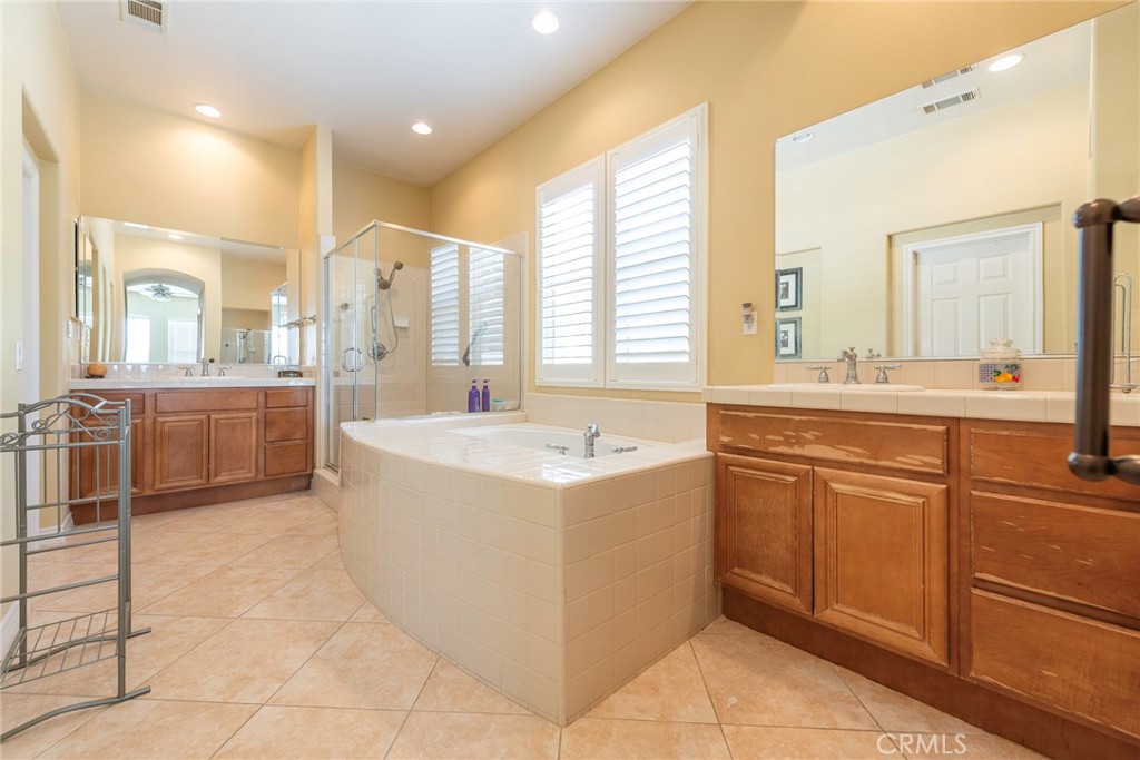 10281 Hillside Road Rancho Cucamonga, CA 91737 - Photo 36 of 60 a bathroom with a tub sink and mirror