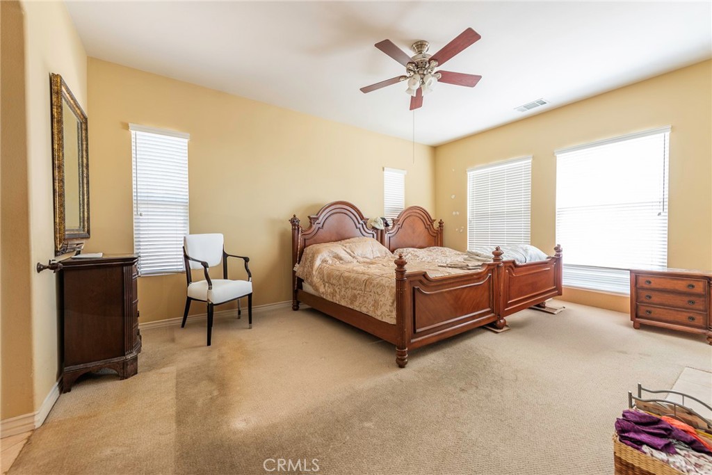 10281 Hillside Road Rancho Cucamonga, CA 91737 - Photo 39 of 60 a bedroom with a bed and wooden floor