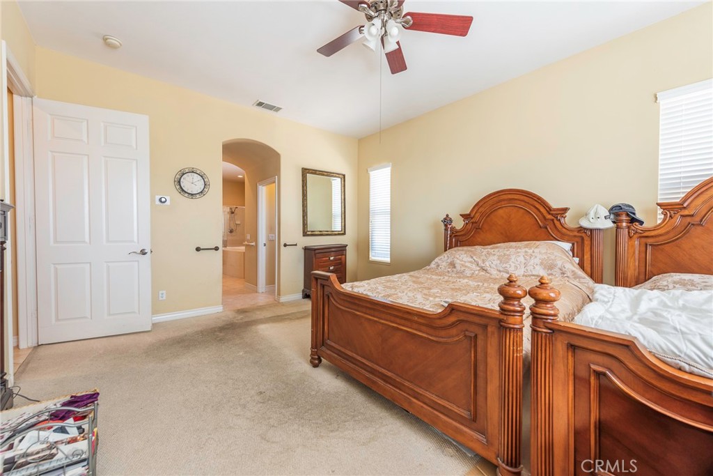 10281 Hillside Road Rancho Cucamonga, CA 91737 - Photo 40 of 60 a bedroom with a bed and a chandelier