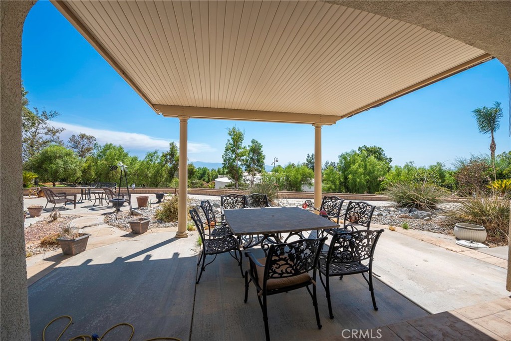 10281 Hillside Road Rancho Cucamonga, CA 91737 - Photo 53 of 60 a view of a patio with a table and chairs under an umbrella