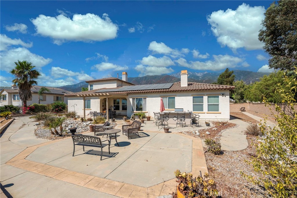10281 Hillside Road Rancho Cucamonga, CA 91737 - Photo 56 of 60 a roof deck with table and chairs under an umbrella