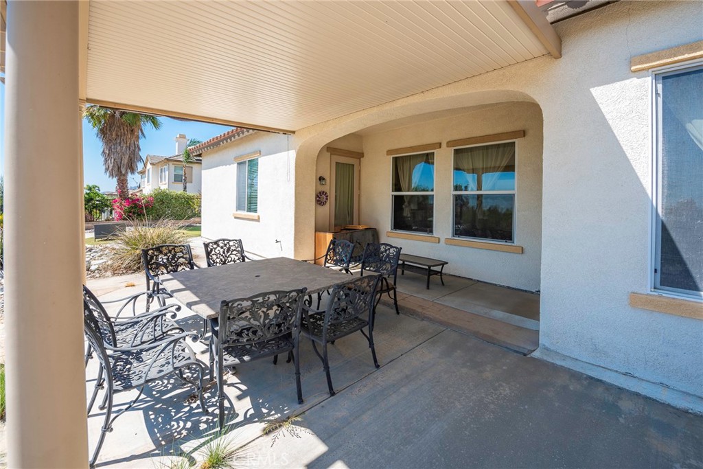 10281 Hillside Road Rancho Cucamonga, CA 91737 - Photo 58 of 60 a view of a patio with table and chairs and potted plants