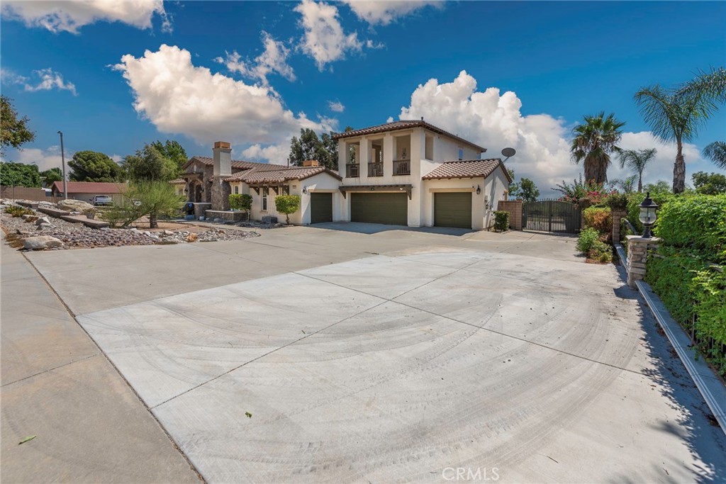10281 Hillside Road Rancho Cucamonga, CA 91737 - Photo 6 of 60 a front view of a house with a yard and garage