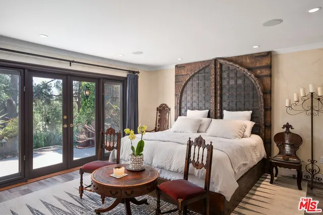 a bedroom with a bed and a painting on the wall