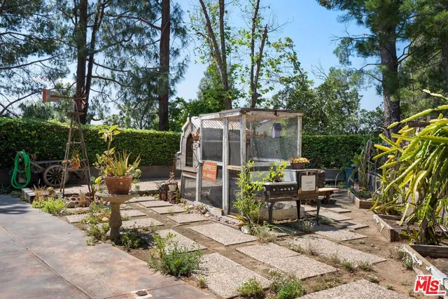 a front view of a house with a garden and patio