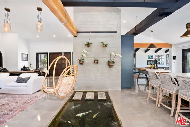 a living room with furniture a rug and white walls