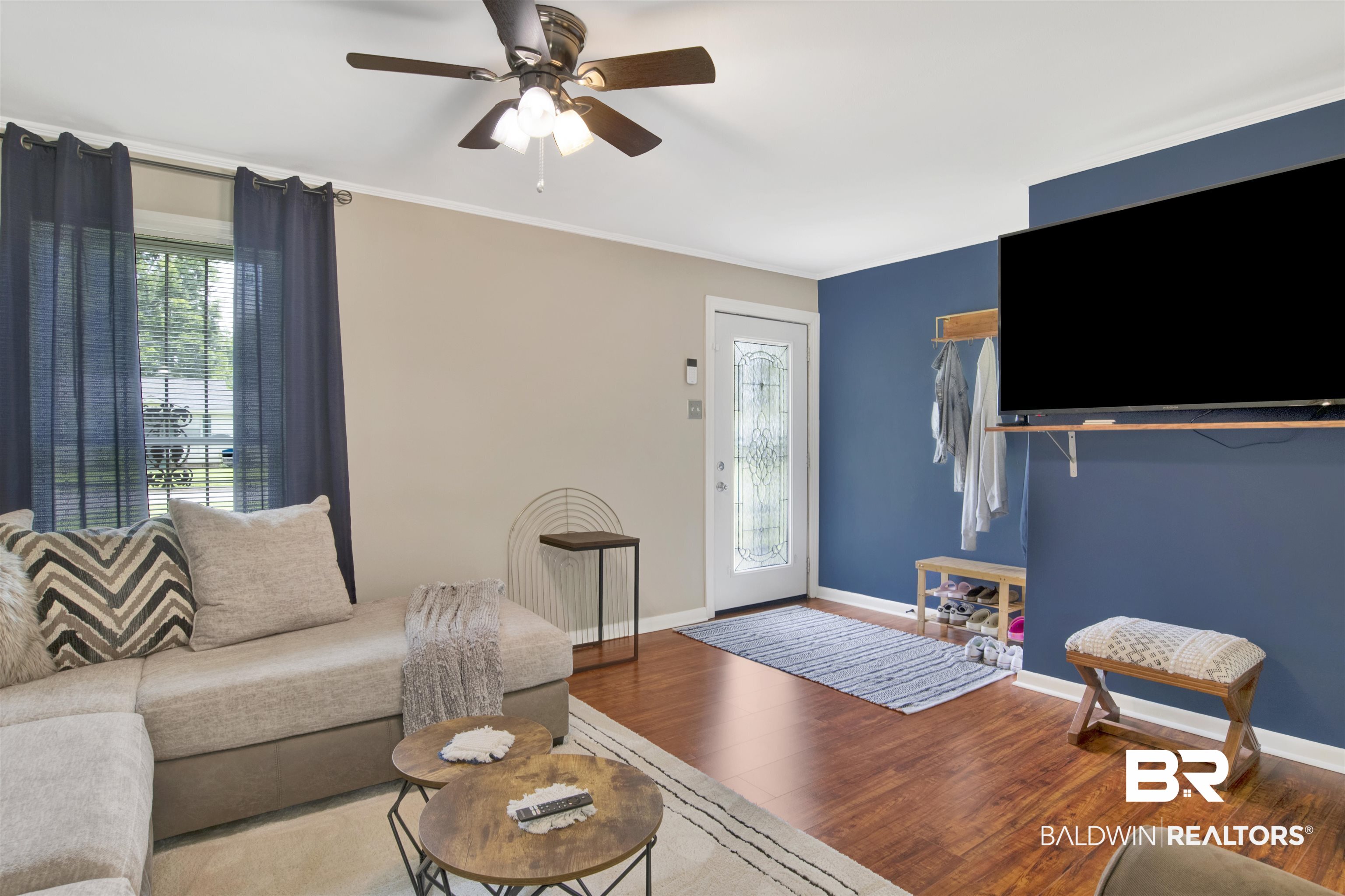 1476 Boudousquie Street Mobile, AL 36605 - Photo 4 of 34 Living area featuring wood finished floors, a ceiling fan, and crown molding