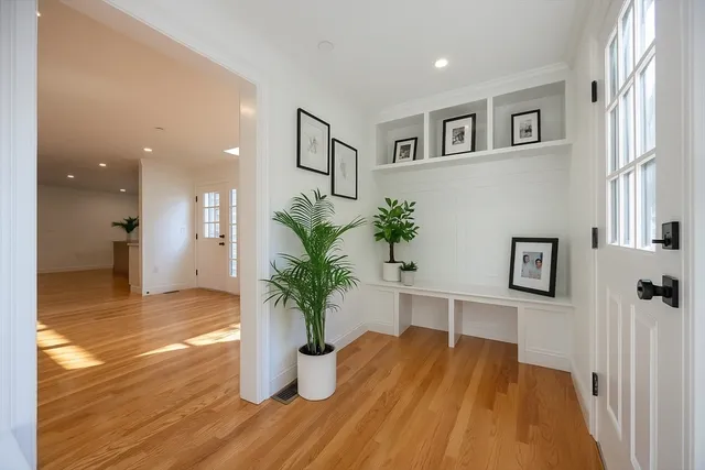 a view of a living room and kitchen with wooden floor