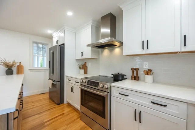 a kitchen with stainless steel appliances a stove a sink and a refrigerator