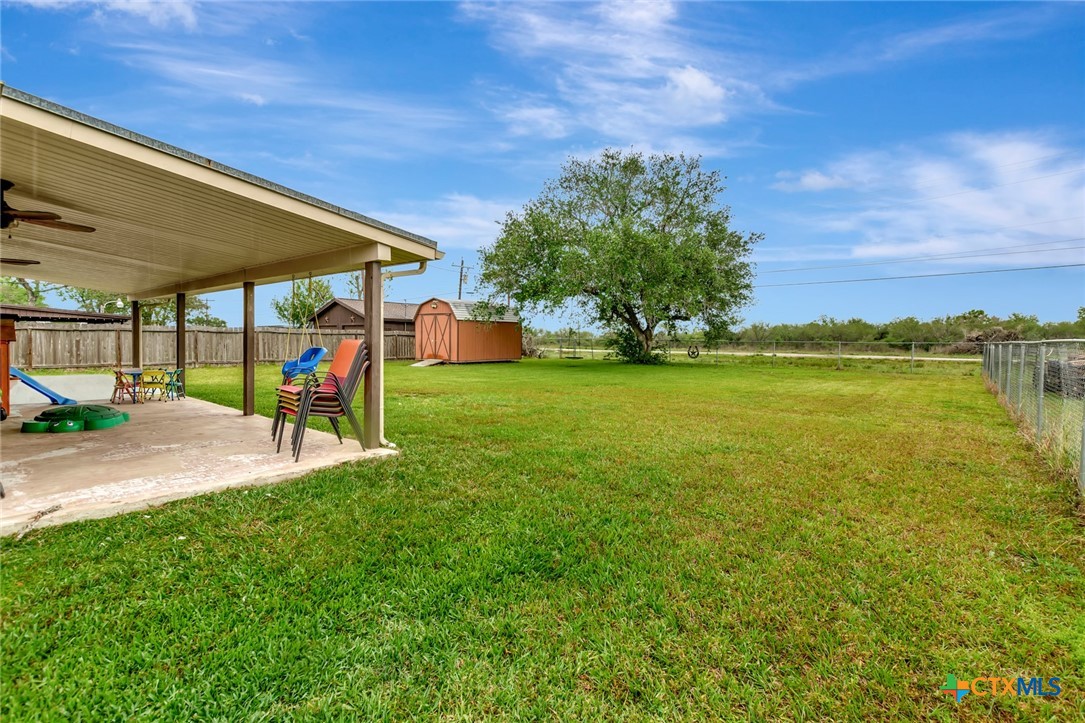 401 Viking Street Victoria, TX 77905 - Photo 16 of 20 a view of a patio with a table and chairs under an umbrella