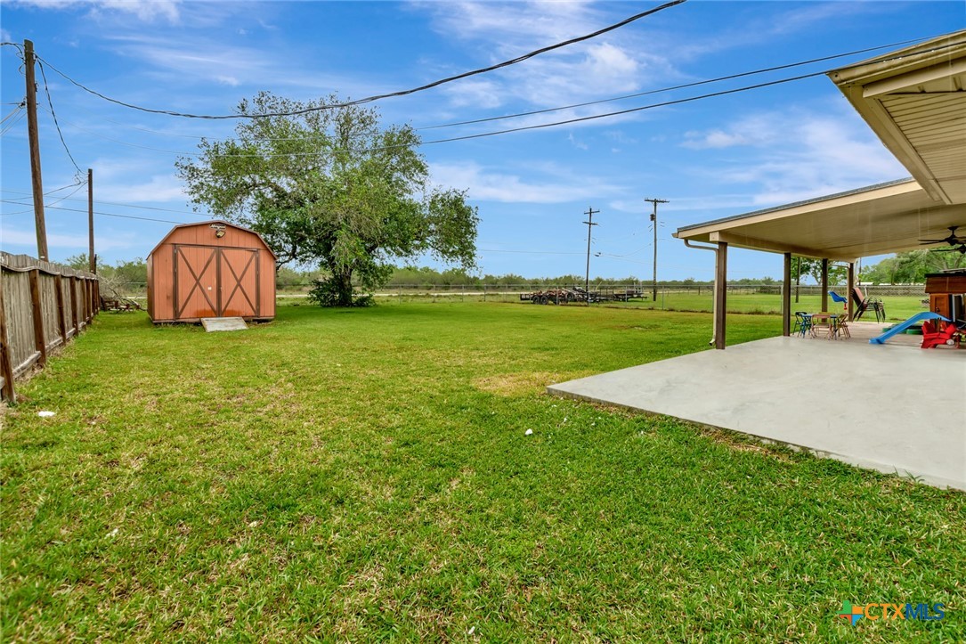 401 Viking Street Victoria, TX 77905 - Photo 17 of 20 a view of a backyard with table and chairs under an umbrella