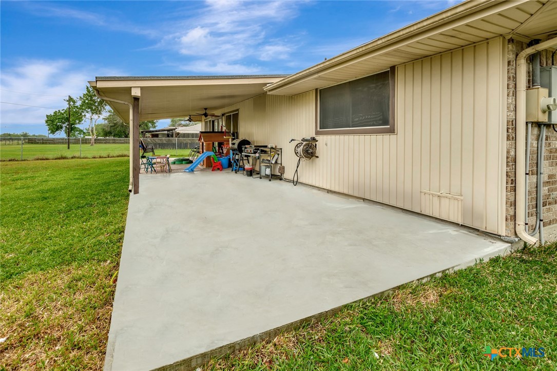 401 Viking Street Victoria, TX 77905 - Photo 18 of 20 a view of a patio with table and chairs under an umbrella