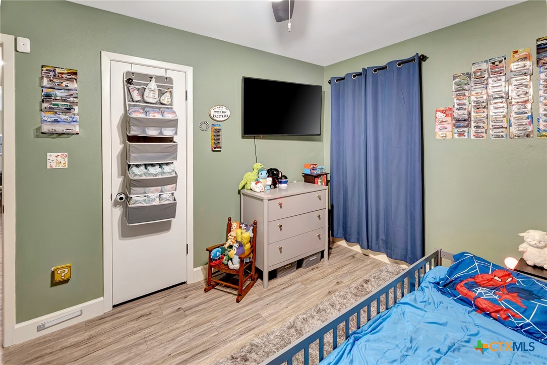 401 Viking Street Victoria, TX 77905 - Photo 9 of 20 a bedroom with a bed and wooden floor