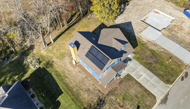 an aerial view of a house with a yard