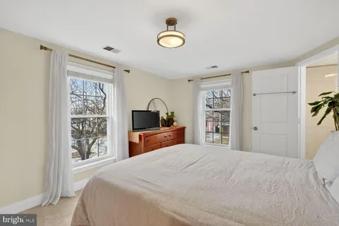 a bedroom with a large bed and a window