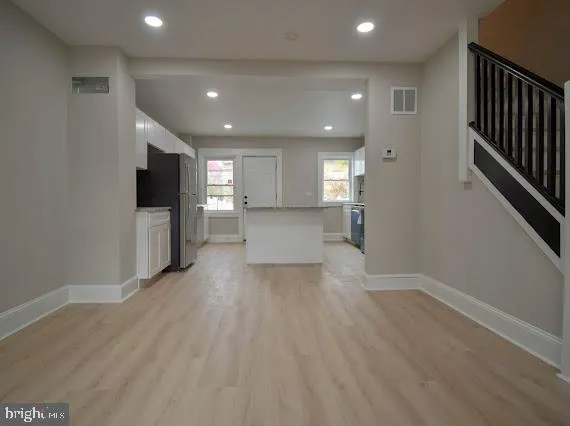 a view of livingroom with hardwood floor and a ceiling fan