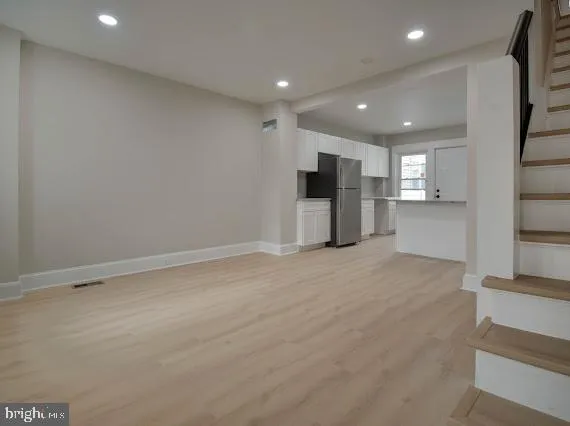 a view of a kitchen with a refrigerator and a sink