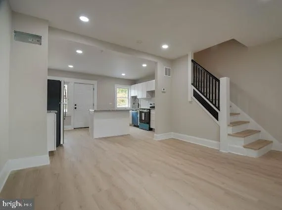 a view of a kitchen with a sink and a refrigerator