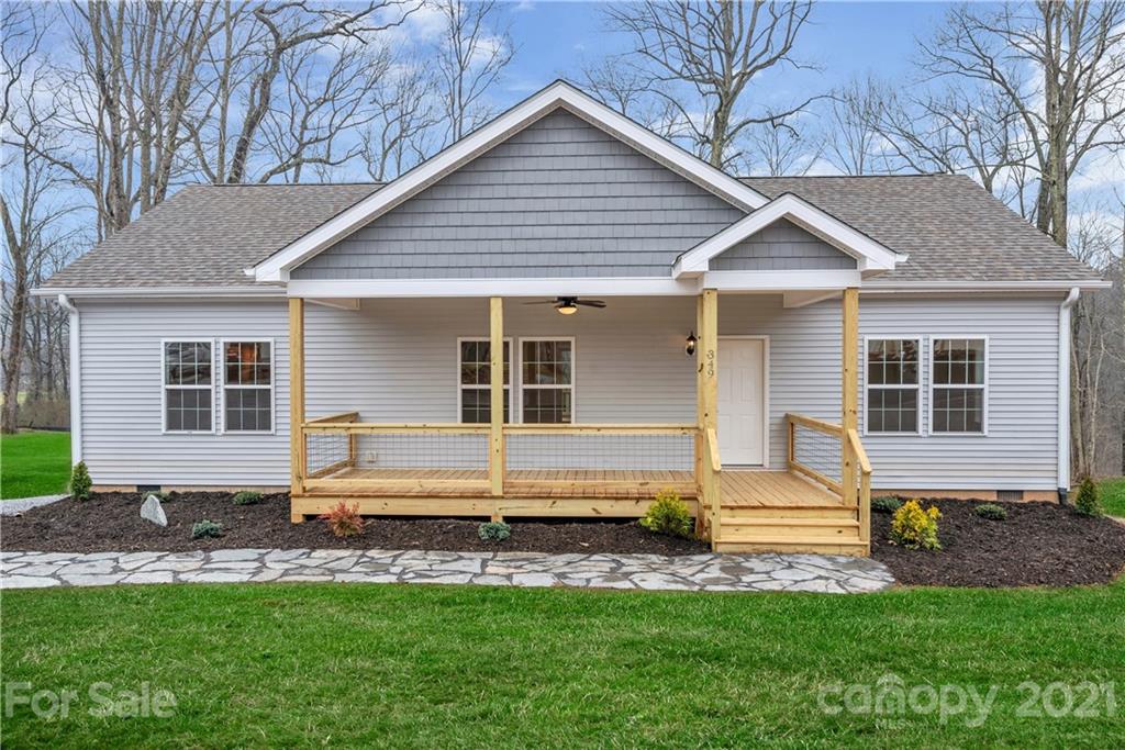 349 Ridge View Drive, Unit 3 Clyde, NC 28721 - Photo 1 of 20 a front view of a house with a yard and porch