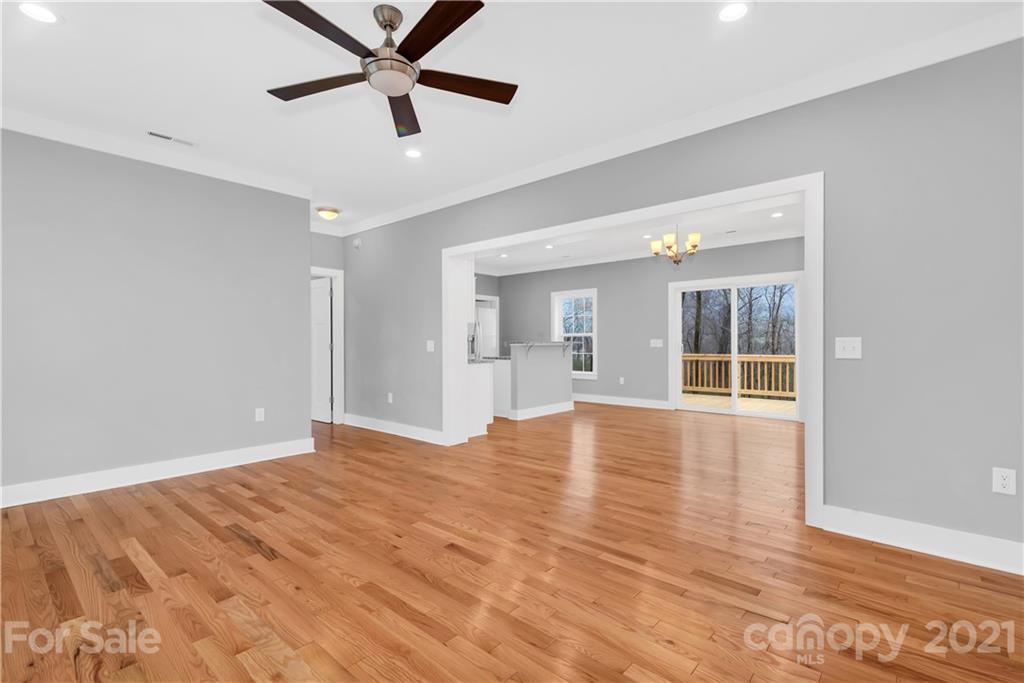 349 Ridge View Drive, Unit 3 Clyde, NC 28721 - Photo 5 of 20 a view of an empty room with window and wooden floor