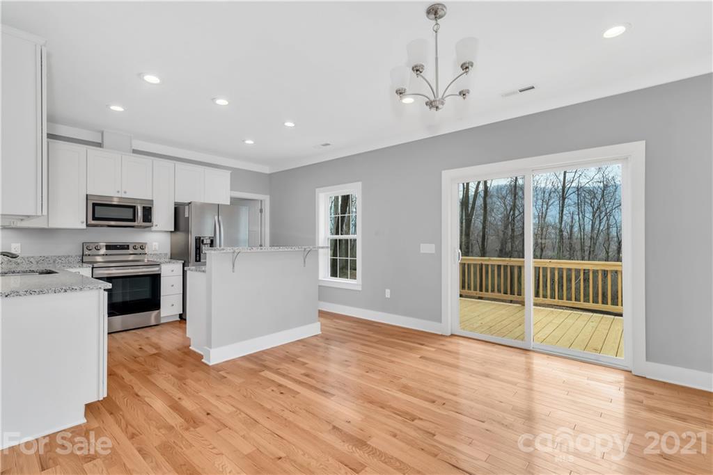 349 Ridge View Drive, Unit 3 Clyde, NC 28721 - Photo 7 of 20 a kitchen with stainless steel appliances a refrigerator and a stove top oven