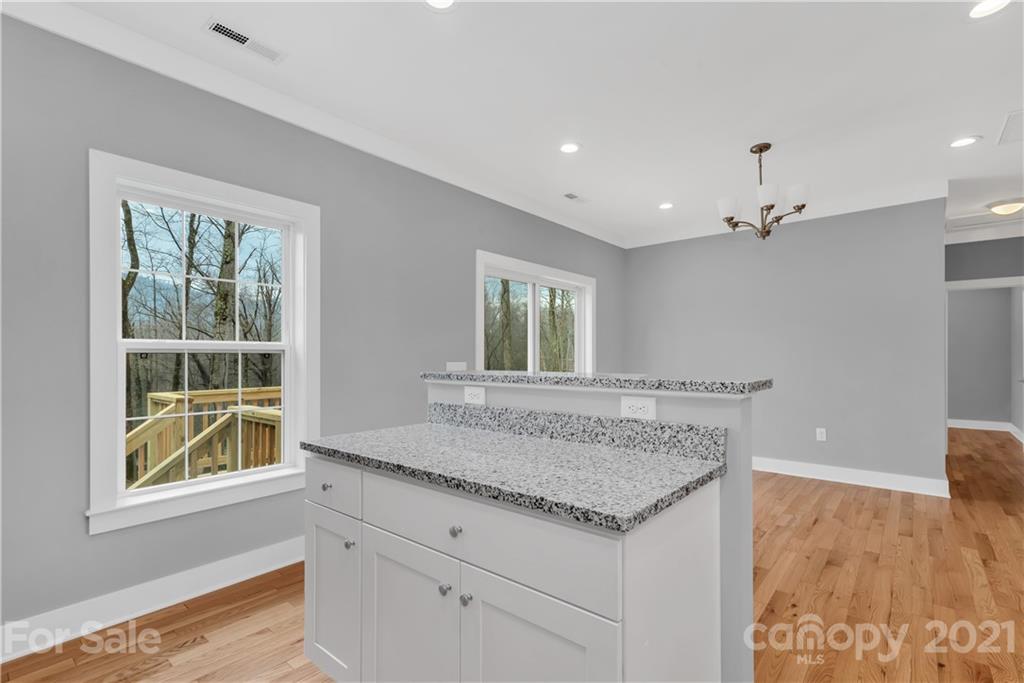 349 Ridge View Drive, Unit 3 Clyde, NC 28721 - Photo 10 of 20 a view of kitchen with granite countertop cabinets and window