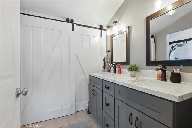 a bathroom with a double vanity sink and a mirror