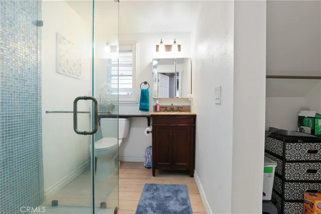 a en suite bathroom with a granite countertop sink and a mirror