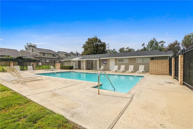 a house with swimming pool in front of it