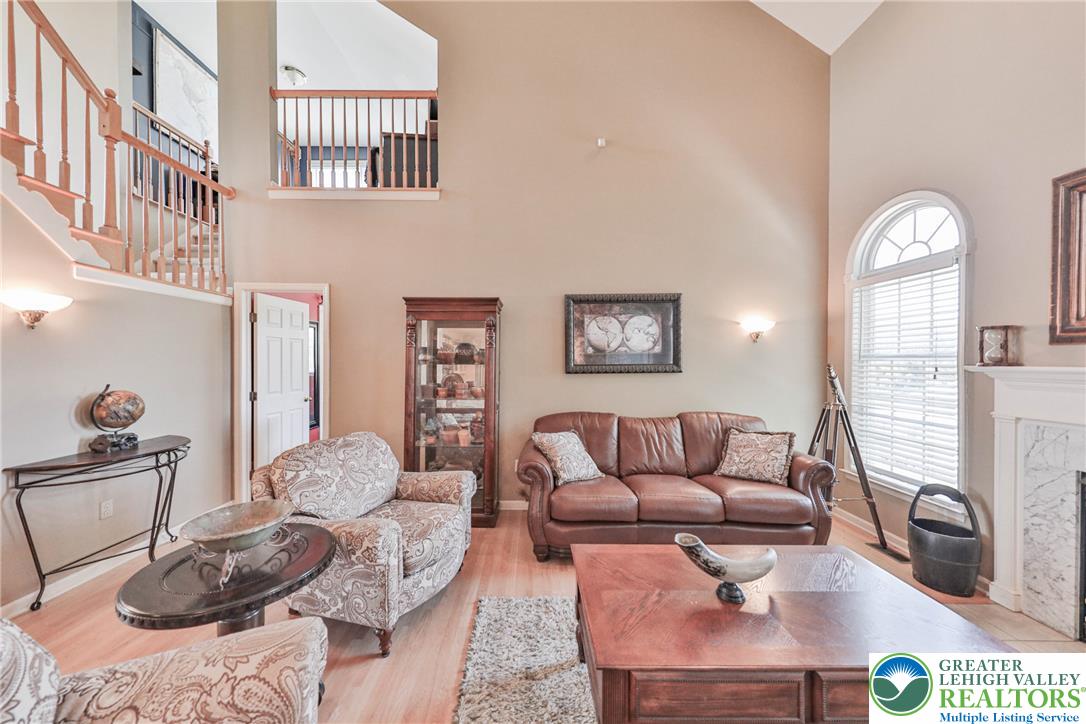 63 Long Road Lenhartsville, PA 19534 - Photo 42 of 100 High vaulted ceilings and a classic fireplace anchor this airy, light-filled living space.