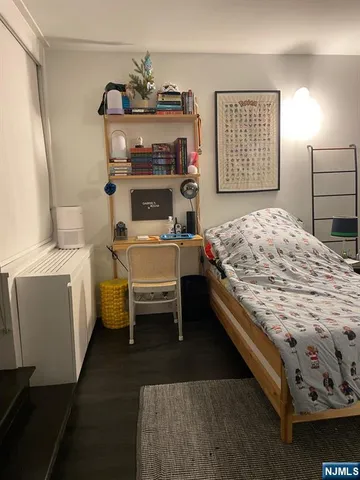 a bed room with a bed and a chair