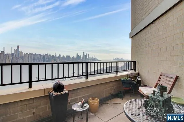 a balcony with table and chairs