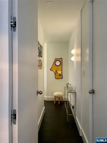 a view of a hallway with chairs and closet