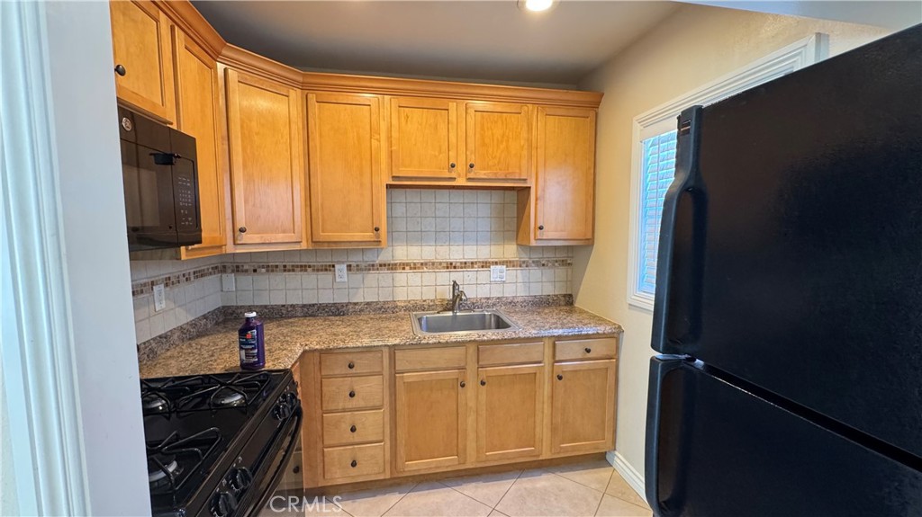 911 Genoa Street, Unit A Monrovia, CA 91016 - Photo 5 of 9 a kitchen with a sink and a refrigerator