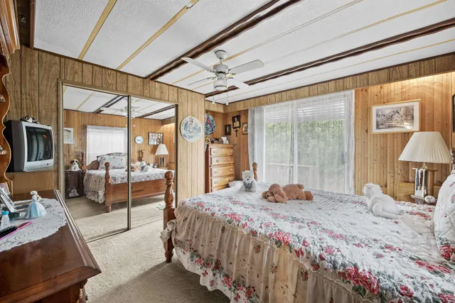 a bedroom with a large bed and a large window