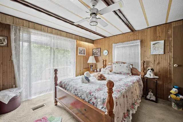 a bedroom with a bed and a mirror