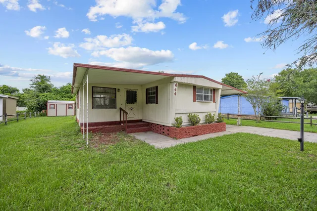 a view of a house with a yard porch and sitting area