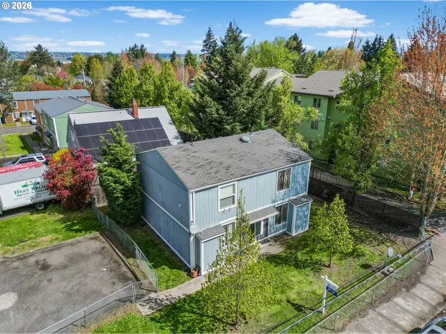 an aerial view of a house with a yard