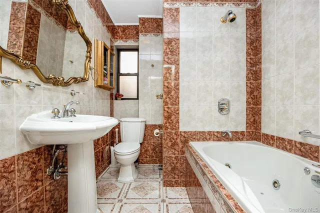 a bathroom with a sink and mirror with bathtub