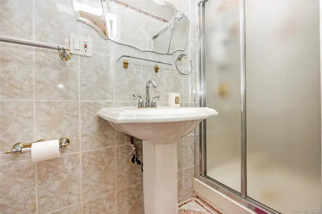 a bathroom with a sink mirror and shower