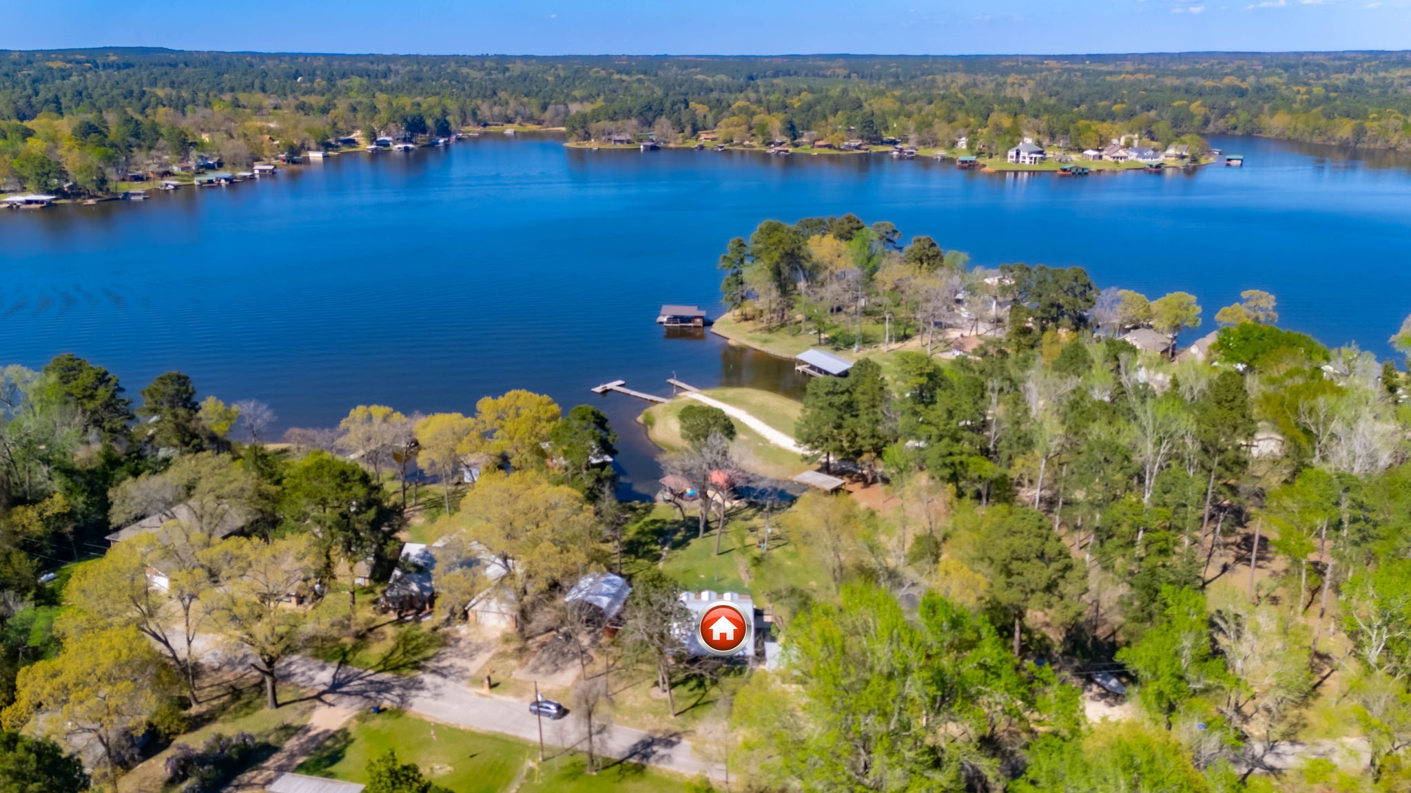 an aerial view of a houses with a lake view