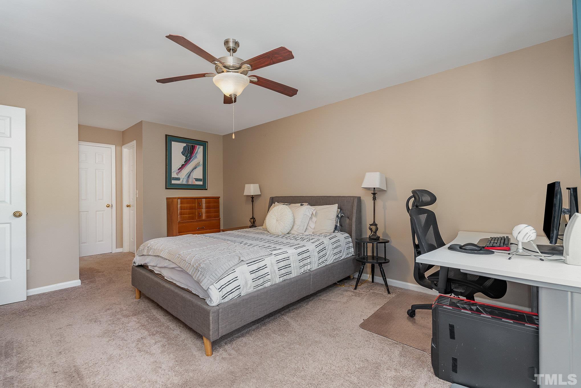 101 Autumn Chase Drive Raleigh, NC 27613 - Photo 11 of 18 a bedroom with a bed and a chandelier