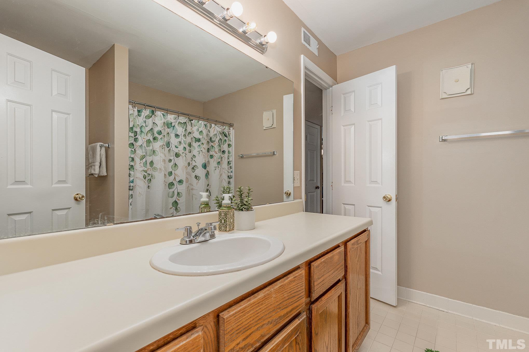 101 Autumn Chase Drive Raleigh, NC 27613 - Photo 12 of 18 a bathroom with a sink and a mirror