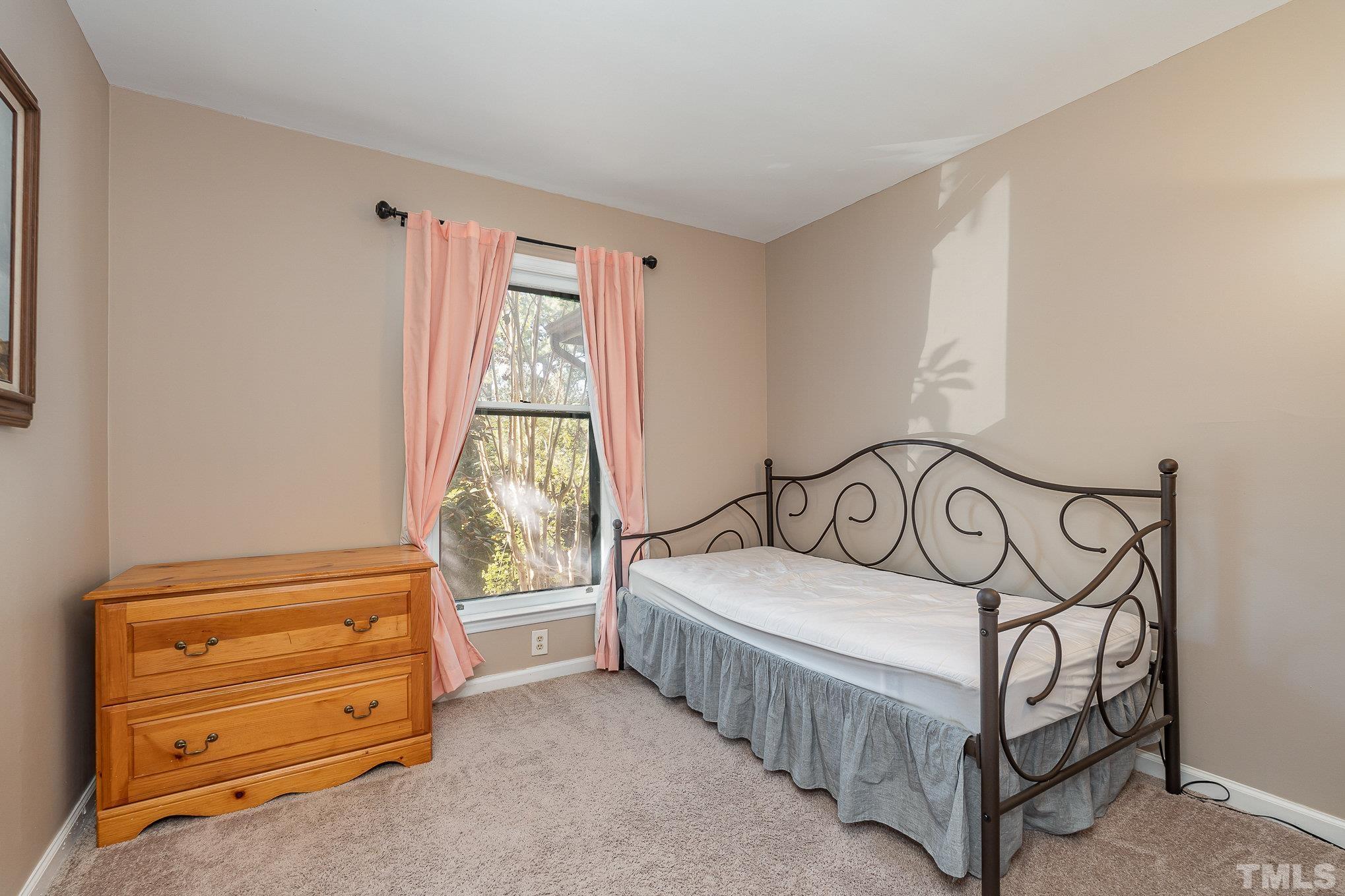 101 Autumn Chase Drive Raleigh, NC 27613 - Photo 13 of 18 a bedroom with a bed and a window