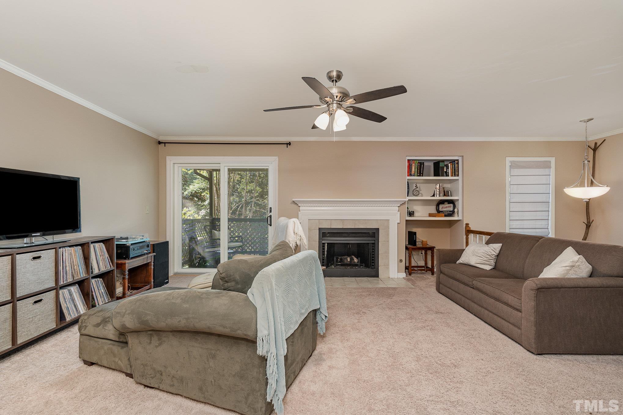 101 Autumn Chase Drive Raleigh, NC 27613 - Photo 4 of 18 a living room with furniture a flat screen tv and a fireplace