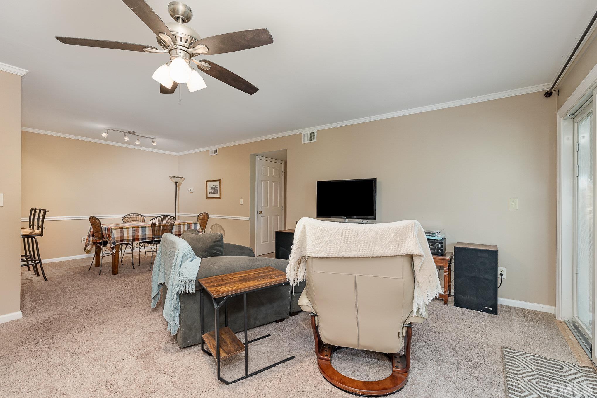 101 Autumn Chase Drive Raleigh, NC 27613 - Photo 6 of 18 a living room with furniture and a flat screen tv