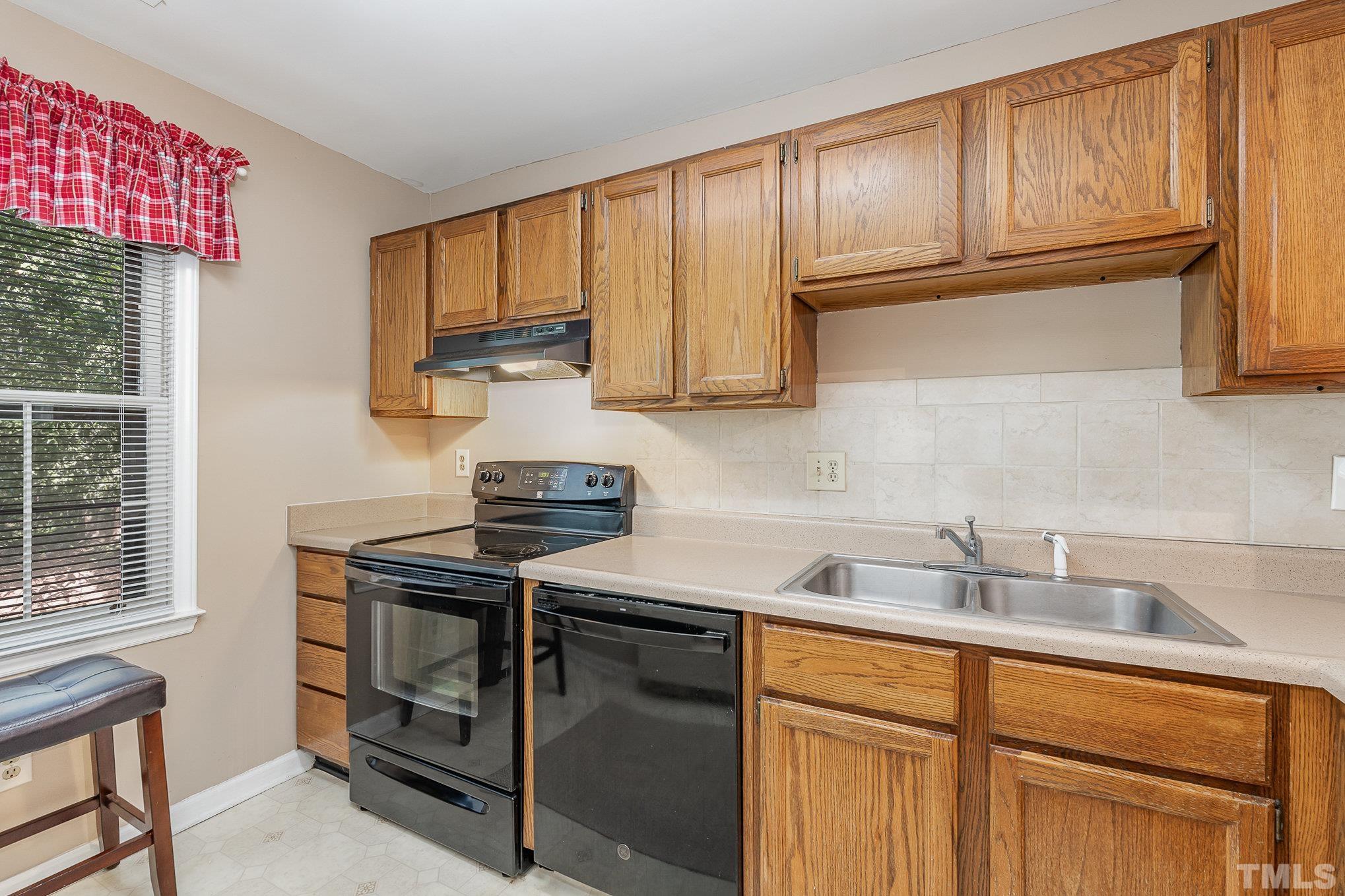 101 Autumn Chase Drive Raleigh, NC 27613 - Photo 8 of 18 a kitchen with stainless steel appliances granite countertop a sink stove and cabinets
